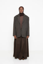 Blazer en laine à carreaux marron pour femme. Coupe oversize.