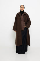 Manteau long marron foncé pour femme voilée.